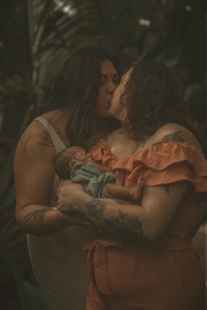 Mother embracing baby outdoors during Home and Wild combined family photography session in Connecticut