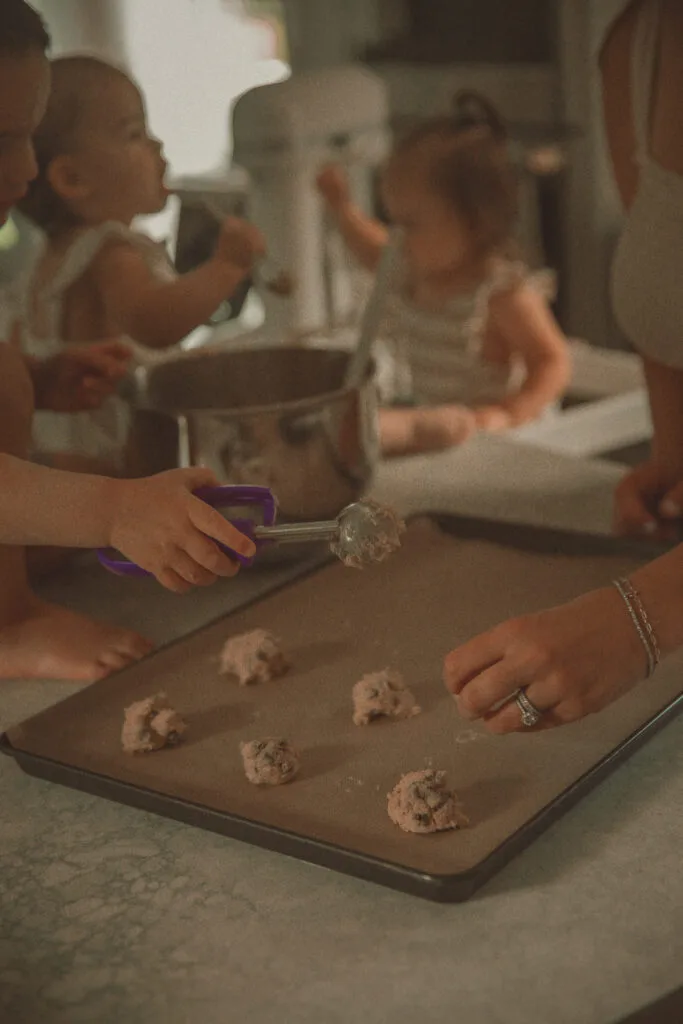 Child making cookies with mom during Home Stories documentary lifestyle session in Connecticut home