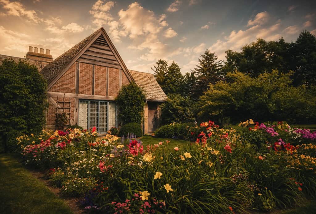 Colorful perennial garden in full bloom alongside Chase Cottage at Topsmead State Forest, a family photography location in Litchfield, Connecticut