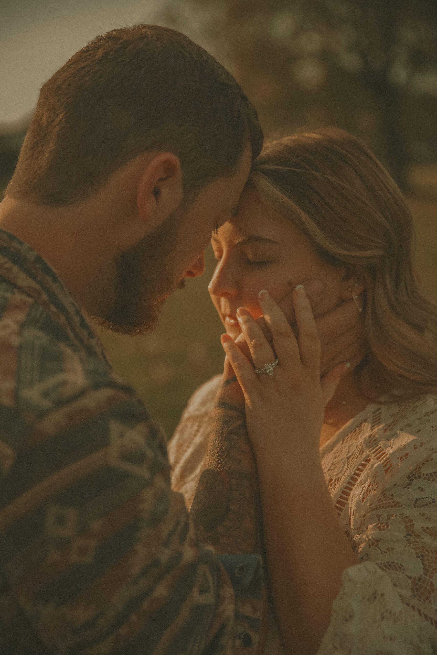Engaged couple touching foreheads at sunset during concept-driven engagement session in Connecticut