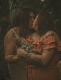 Mother embracing baby outdoors during Home and Wild combined family photography session in Connecticut